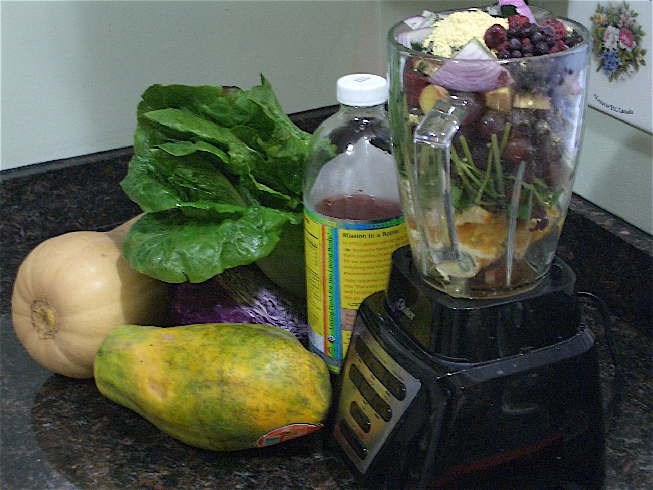 Paleo diet in a Blender - fruits and vegetables, blackberries, blueberries, cilantro, ginger root, lettuce, papaya, red cabbage, red onion, winter squash, pine pollen, bee pollen, chlorella, kombucha
